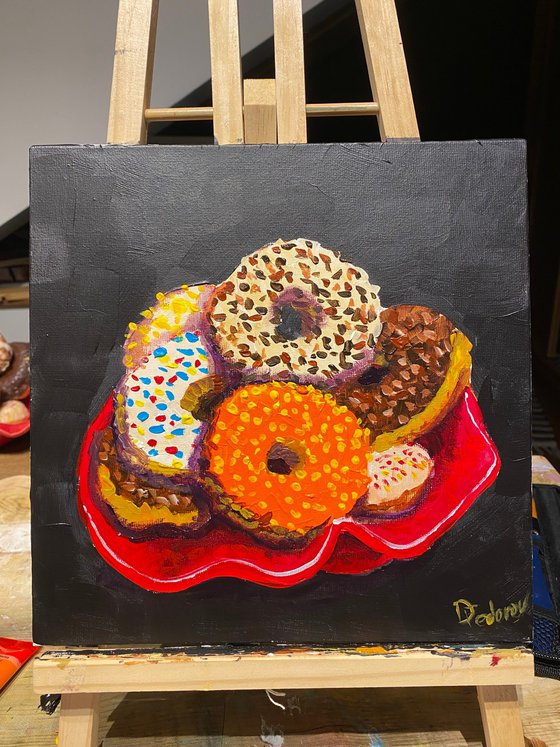 Colourful donuts in red dish