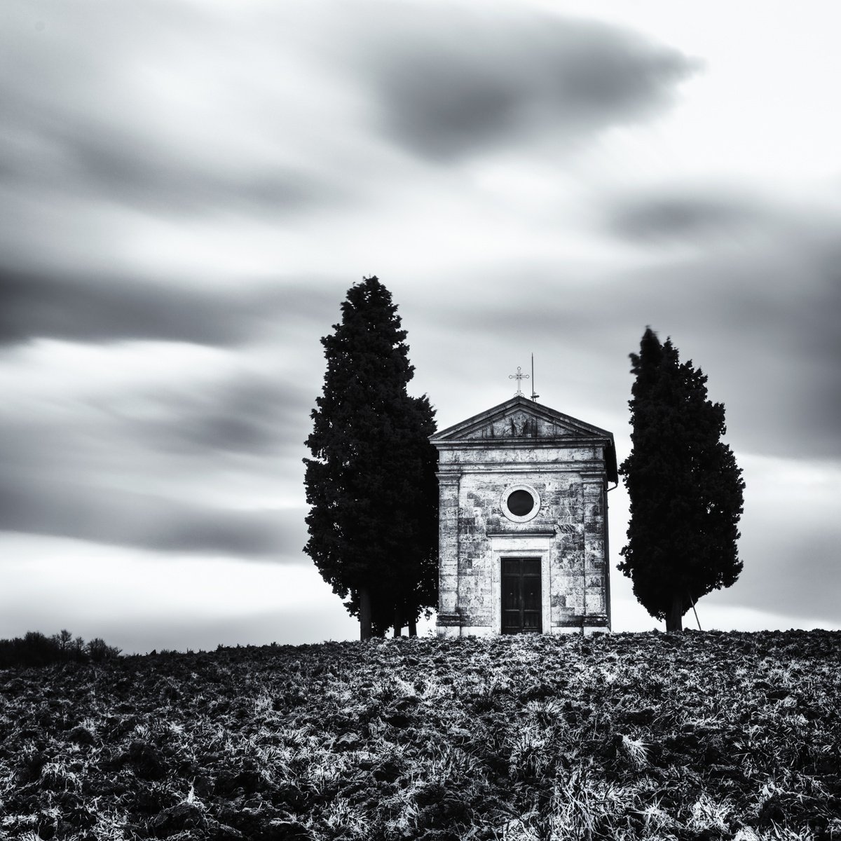 A small chapel with cypresses by Karim Carella