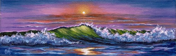 Green wave at colorful sunset