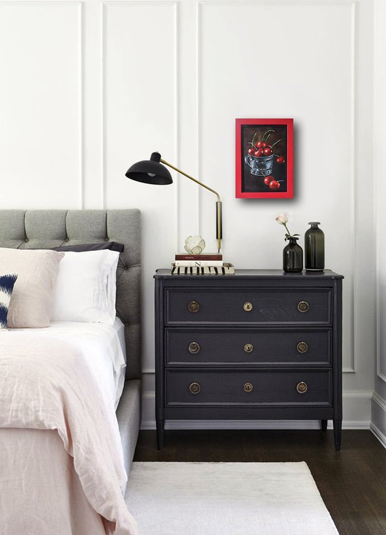 Red cherries in a metal cup