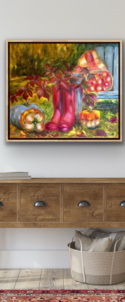 Still life with pink wellingtons, pumpkins and apples in garden by Olga Ivanova