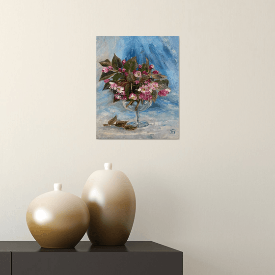 Spring mood. Bouquet in a glass on a blue background.