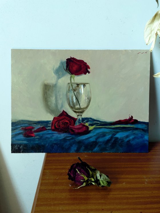 Red rose in empty glass