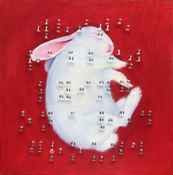 White rabbit lying on a red ground