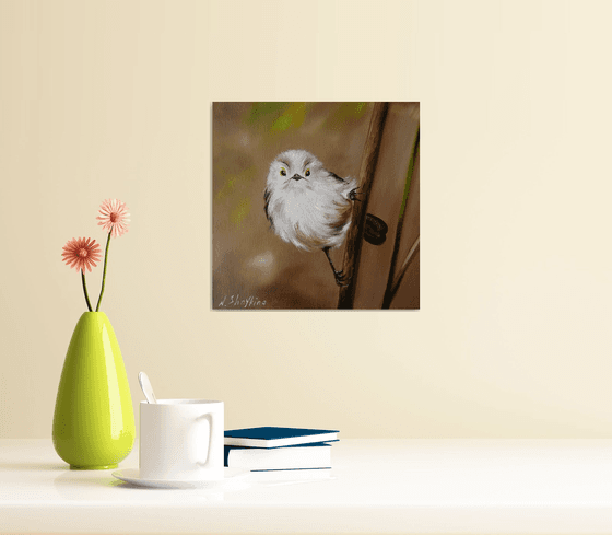 Fluffy White Bird on Branch