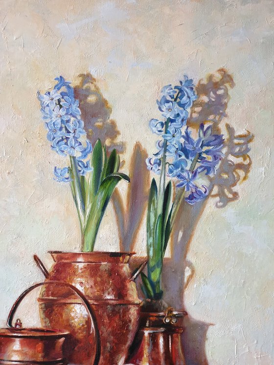 "Blue hyacinths in copper jugs."