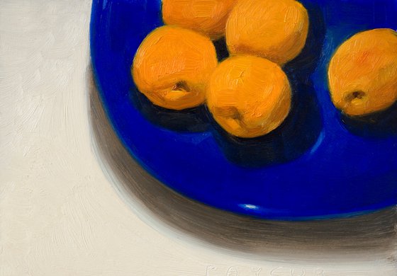 modern still life of apricots on a blue plate