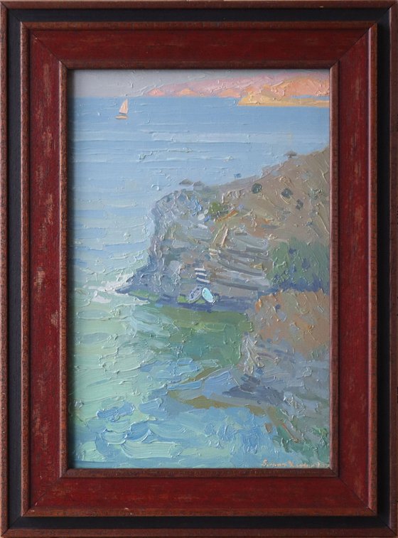 A lonely white sail gleams