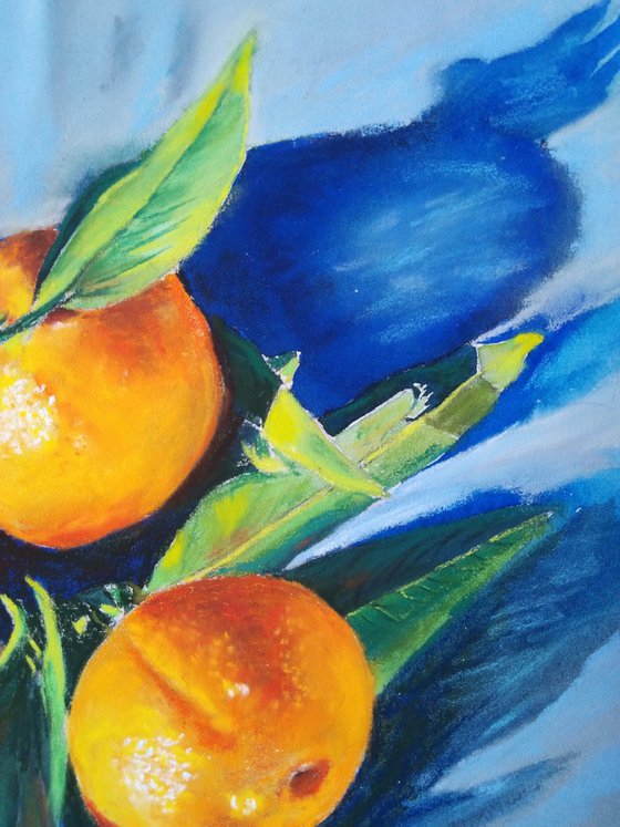 Three tangerines on blue