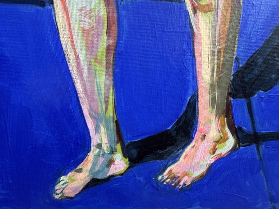 Young nude man in blue room