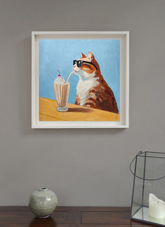 Cat drinking a milkshake