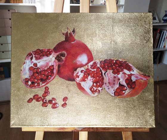 Pomegranate fruit on gold