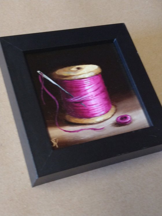 Little pink  cotton reel with button still life