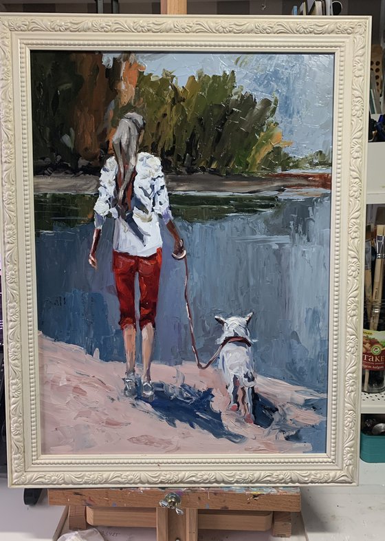 Woman walking with a dog.