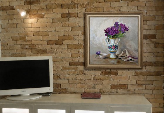 Purple flowers in a colorful jug