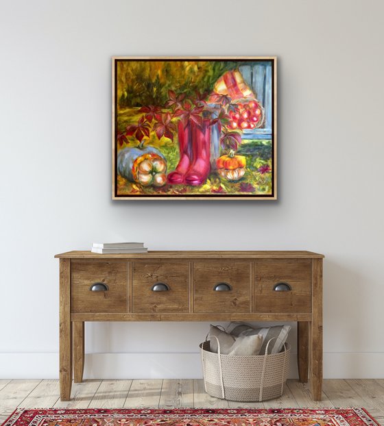 Still life with pink wellingtons, pumpkins and apples in garden