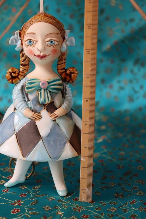 Little Girl in Blue Harlequine Dress. Tiny hanging sculpture