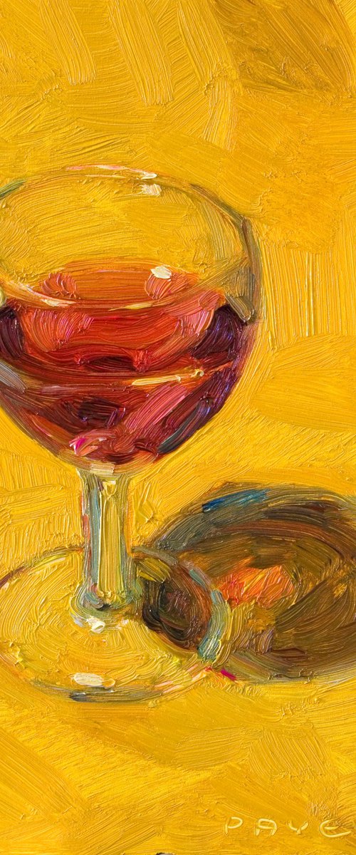 glass of red wine on yellow by Olivier Payeur