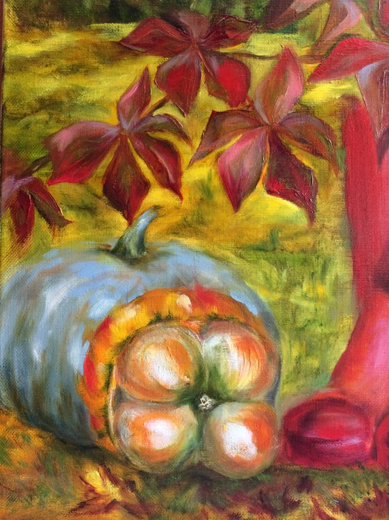 Still life with pink wellingtons, pumpkins and apples in garden