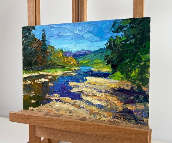 River against the Backdrop of Mountain Slopes