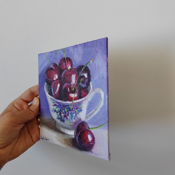 Cherries in porcelain cup