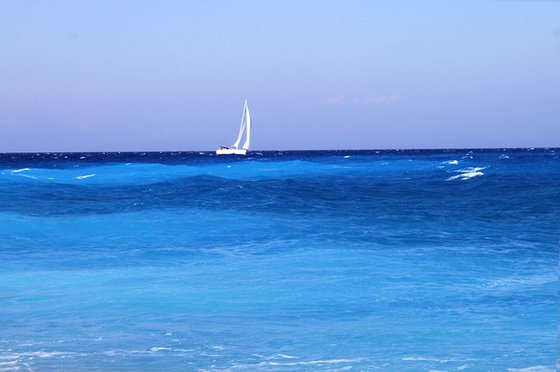 Sailboat on blue waves