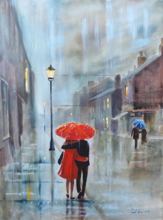 Red in the rain couple with an umbrella