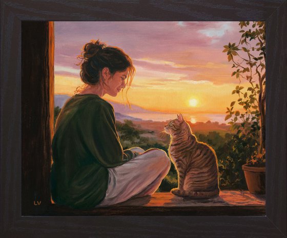 Girl watching the sunset with her tabby cat