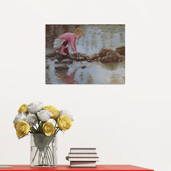 Girl playing by a lake