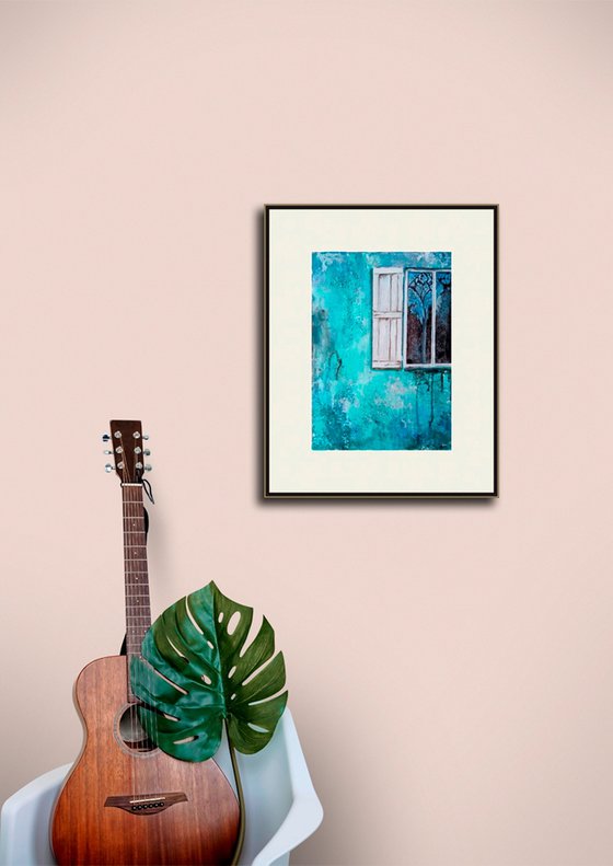 A window in a turquoise wall