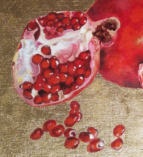 Pomegranate fruit on gold