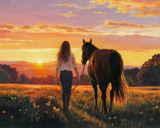 Woman walking with a horse in a sunset field