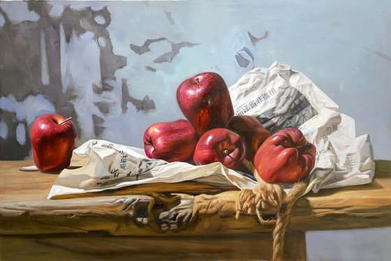 Still life:apples and newspaper on the wooden tables