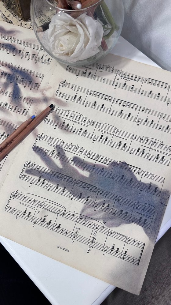 Silhouette Hand And Leaves on Music Sheet