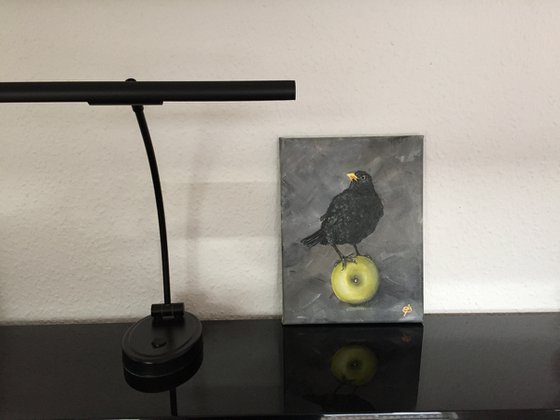 Black bird with apple