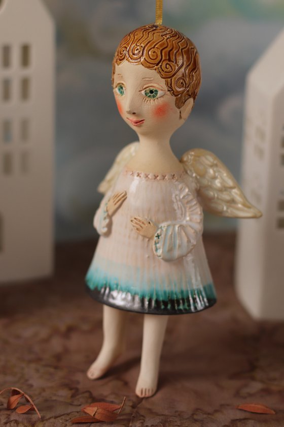 Tiny hanging sculpture by Elya Yalonetski. Smiling Angel