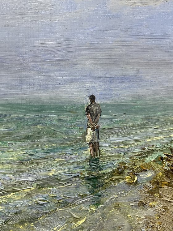 Lonely man at the rocky sea