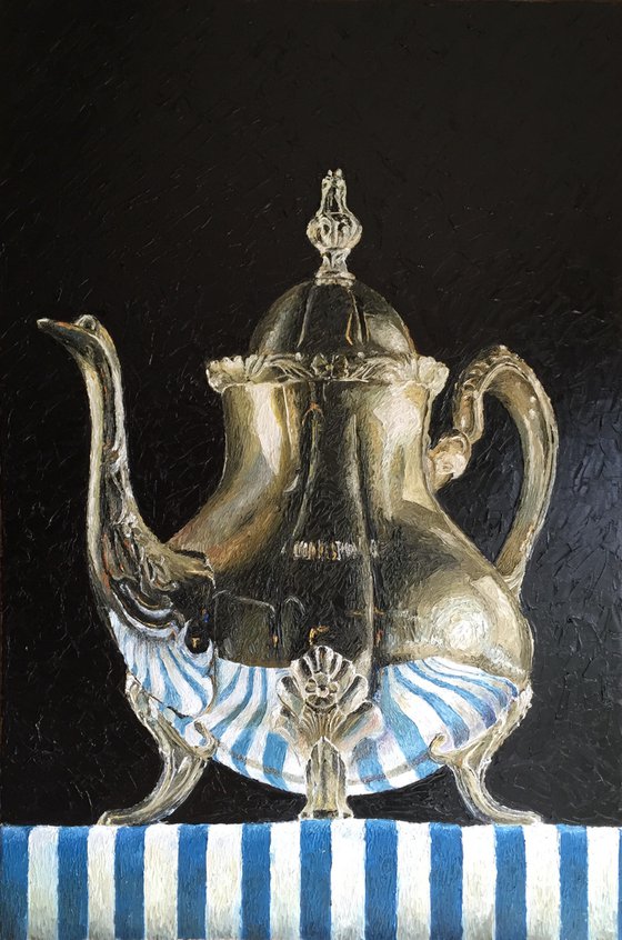 Teapot on blue striped fabric