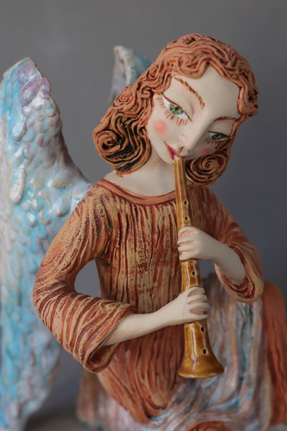 Sitting Angel with a flute. Ceramic OOAK sculpture.