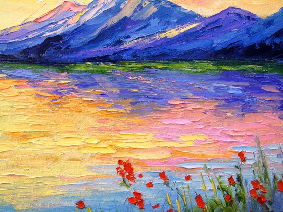 Poppies on the lake by the mountains