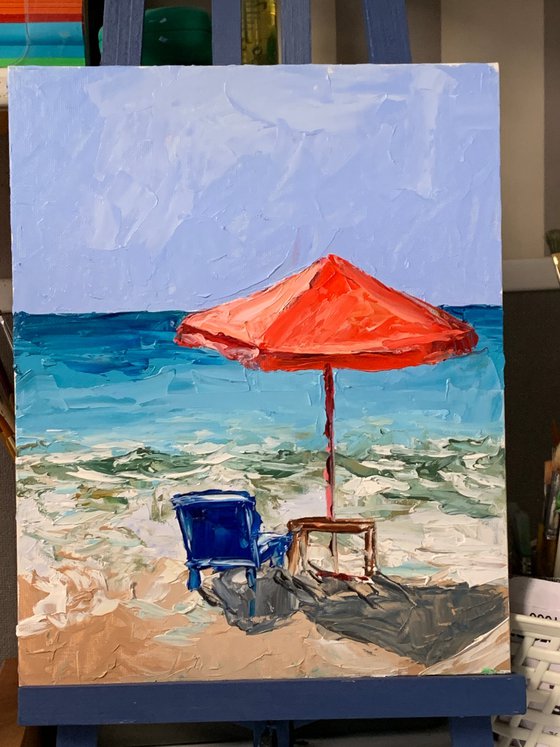 Red parasol on the beach.