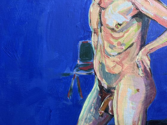 Young nude man in blue room