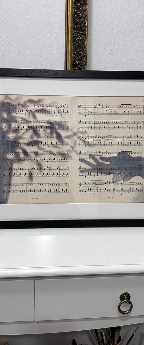 Silhouette Hand And Leaves on Music Sheet by Julia Shilo