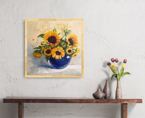 Sunflowers bouquet in a blue glass vase still life