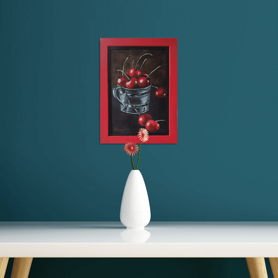 Red cherries in a metal cup