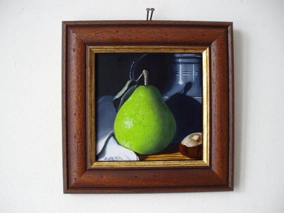 Still life of Pear with pewter and conker