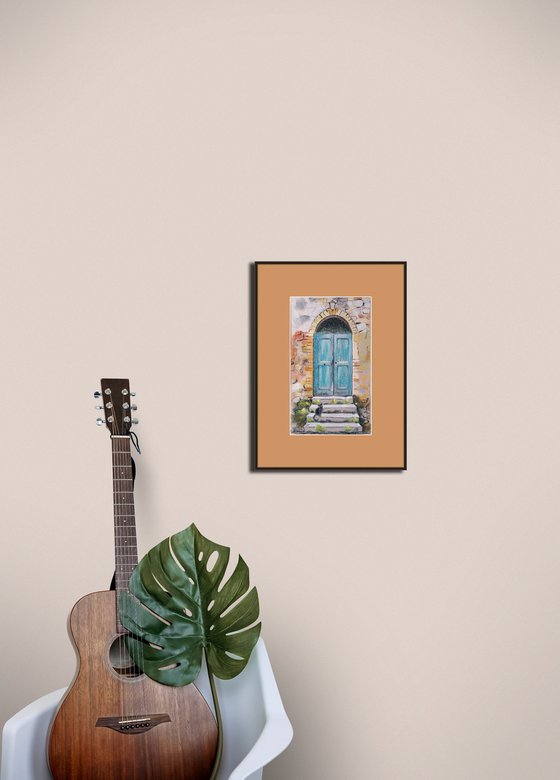 A cat at an old turquoise door