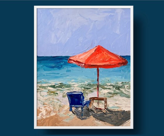 Red parasol on the beach.