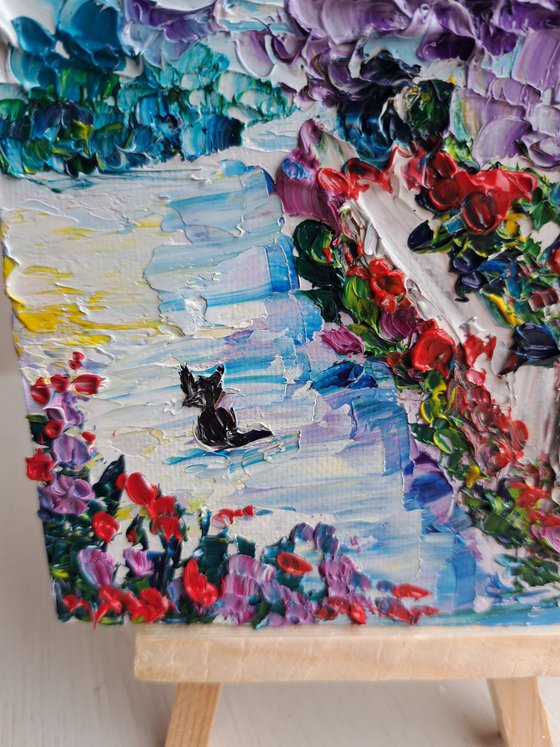 Village flowers and black cat