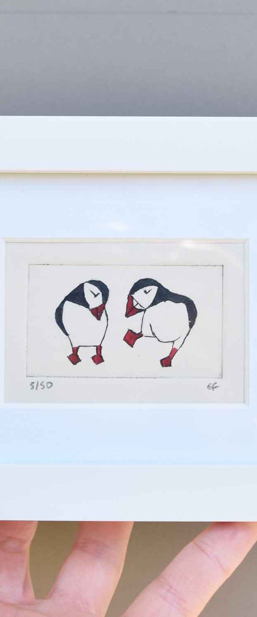 Small framed two puffins (one dancing, one coy) by Sally Fisher